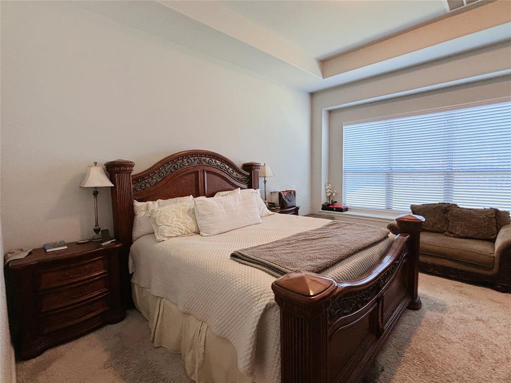 556 England Street Fate, TX 75189 - Photo 8 of 14 a bedroom with a bed and a couch