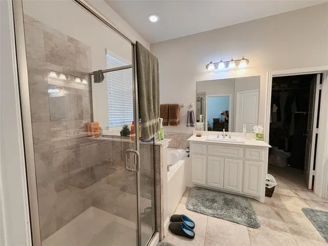 a bathroom with a double vanity sink mirror and shower