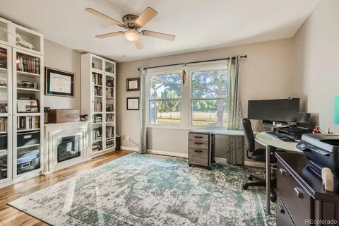 a view of a workspace with furniture and a window