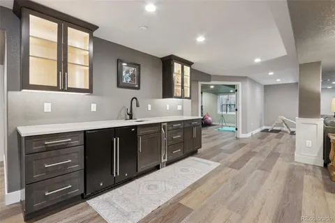 a large kitchen with kitchen island a sink stainless steel appliances and cabinets