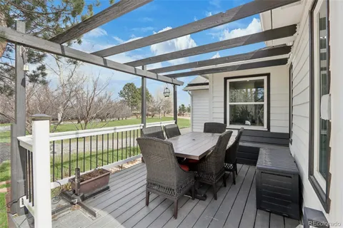 a view of a dining table and chairs on the roof deck