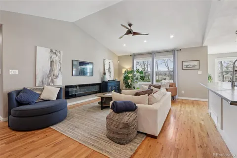 a living room with furniture and a wooden floor