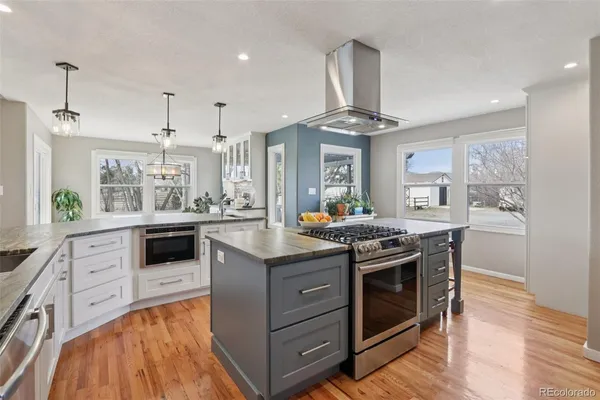 a kitchen with stainless steel appliances granite countertop a stove and a sink