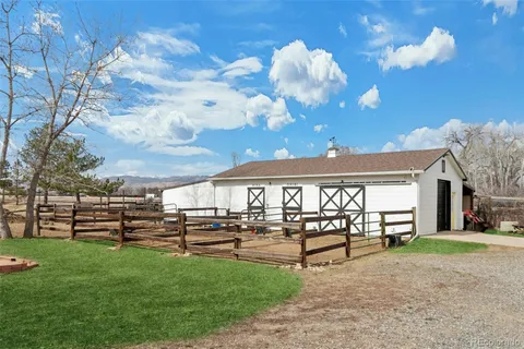 a view of a house with backyard and a tree