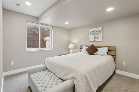 a bedroom with bed and a window