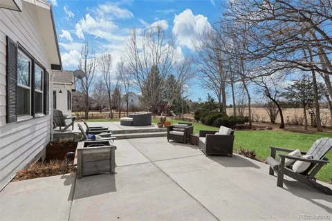 a view of a patio with couches and a fire pit