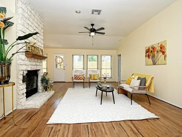 a living room with furniture a fireplace and a table