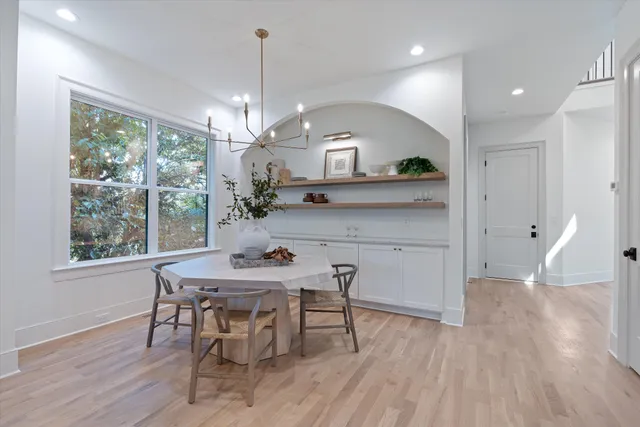 a living room with patio furniture and a floor to ceiling window