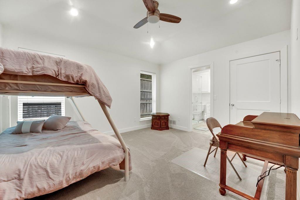 4035 Cedarview Road Dallas, TX 75287 - Photo 12 of 31 a bedroom with a bed and a chandelier