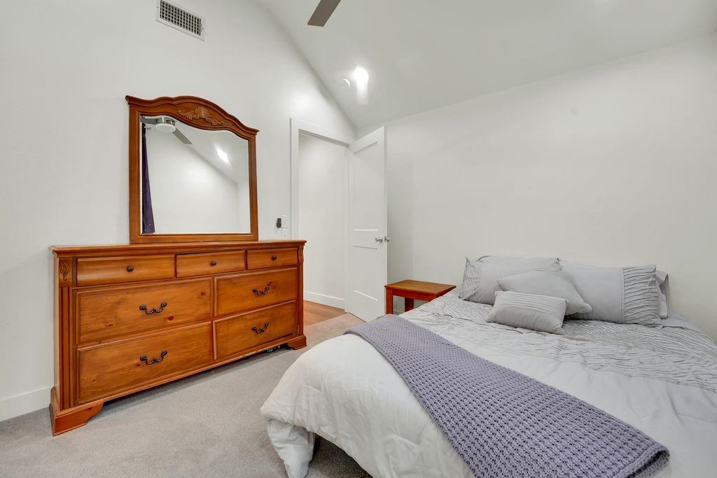 4035 Cedarview Road Dallas, TX 75287 - Photo 17 of 31 a bedroom with a bed and a mirror on dresser