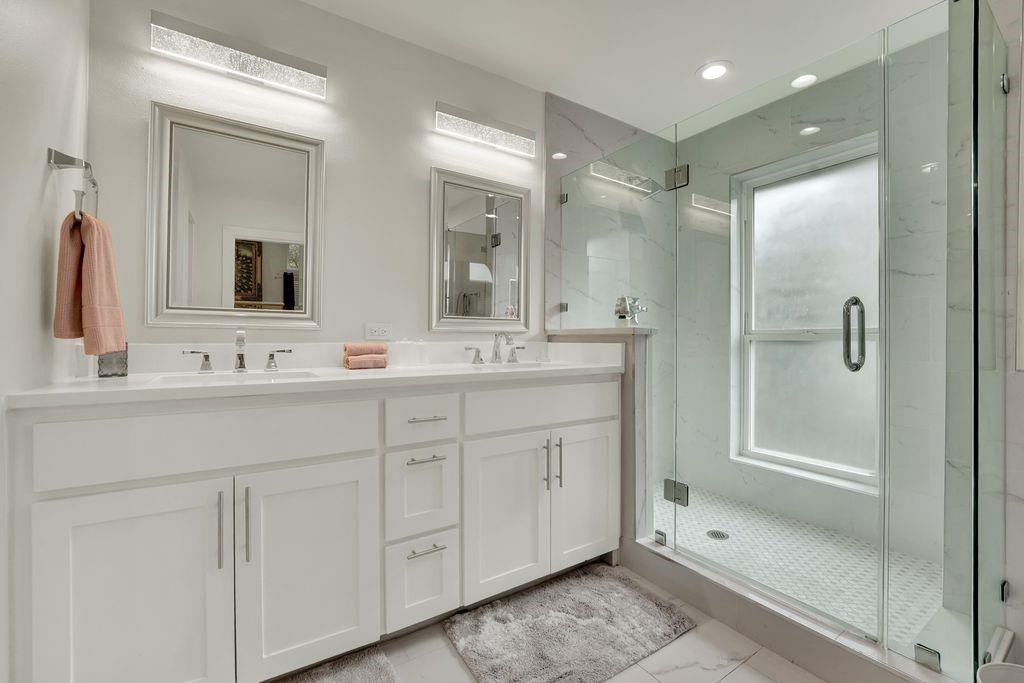 4035 Cedarview Road Dallas, TX 75287 - Photo 19 of 31 a bathroom with double sink and a mirror
