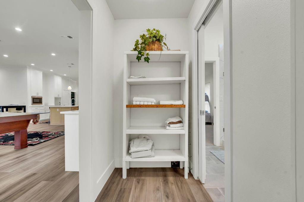 4035 Cedarview Road Dallas, TX 75287 - Photo 22 of 31 a view of a hallway view with wooden floor and furniture