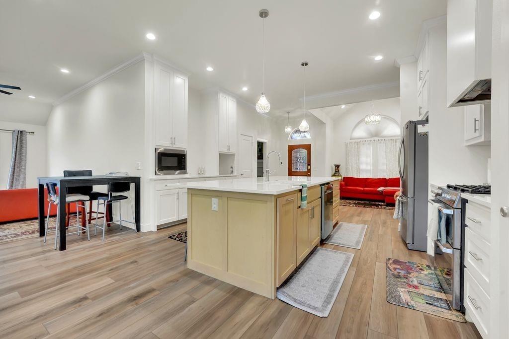 4035 Cedarview Road Dallas, TX 75287 - Photo 25 of 31 a large kitchen with a table and chairs in it