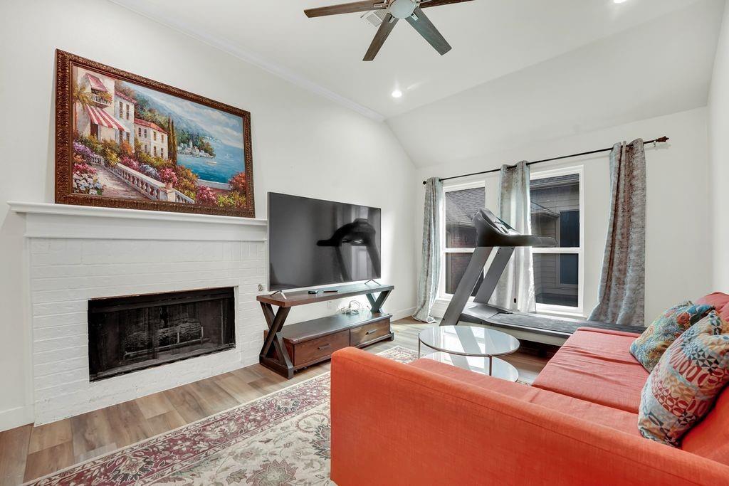 4035 Cedarview Road Dallas, TX 75287 - Photo 27 of 31 a living room with furniture a fireplace and a flat screen tv
