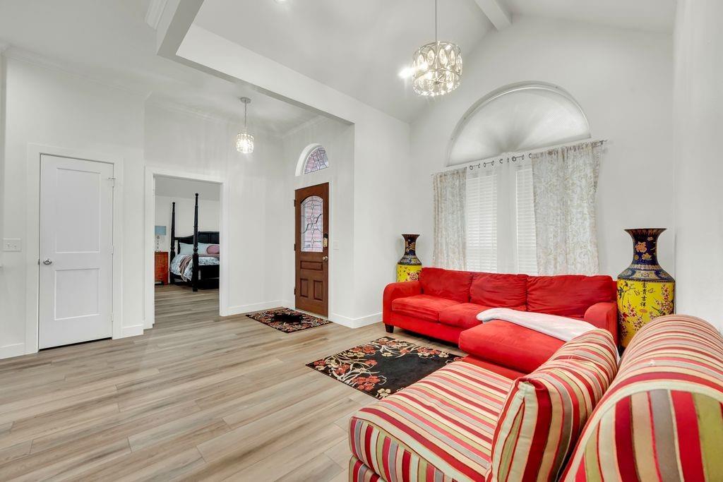 4035 Cedarview Road Dallas, TX 75287 - Photo 3 of 31 a bedroom with a bed and a chandelier