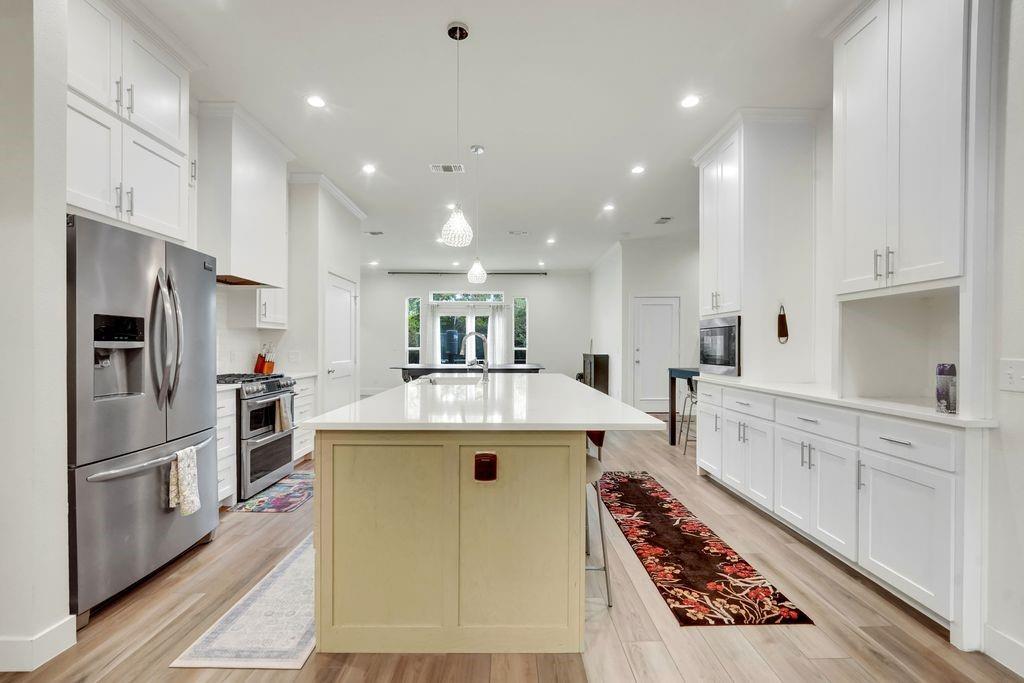 4035 Cedarview Road Dallas, TX 75287 - Photo 9 of 31 a kitchen with counter top space stainless steel appliances and wooden floor