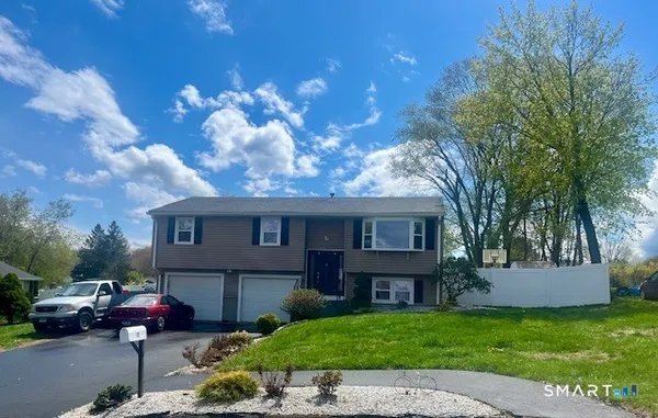 a view of a house with a backyard