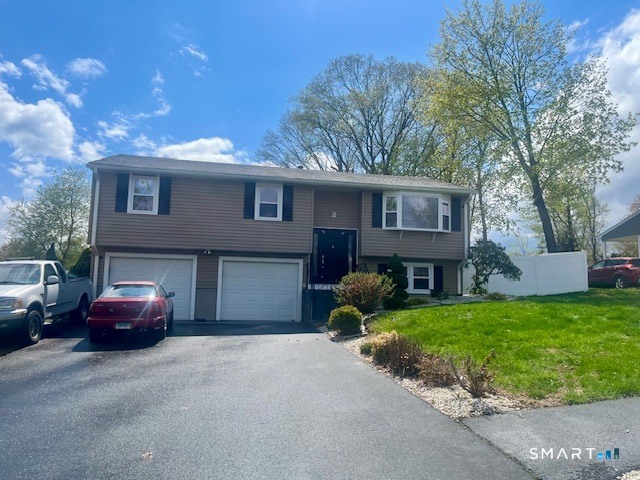 34 Keats Road Meriden, CT 06451 - Photo 2 of 19 a front view of a house with a garden and garage