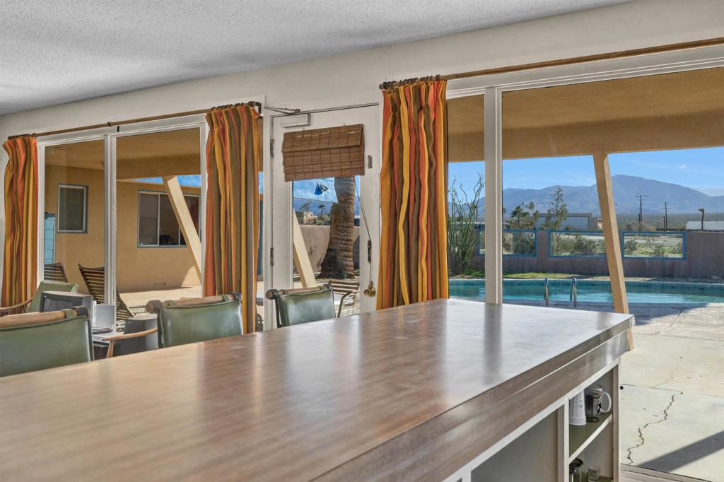 4235 Fletcher Road Borrego Springs, CA 92004 - Photo 12 of 31 a view of a living room with a floor to ceiling window and wooden floor