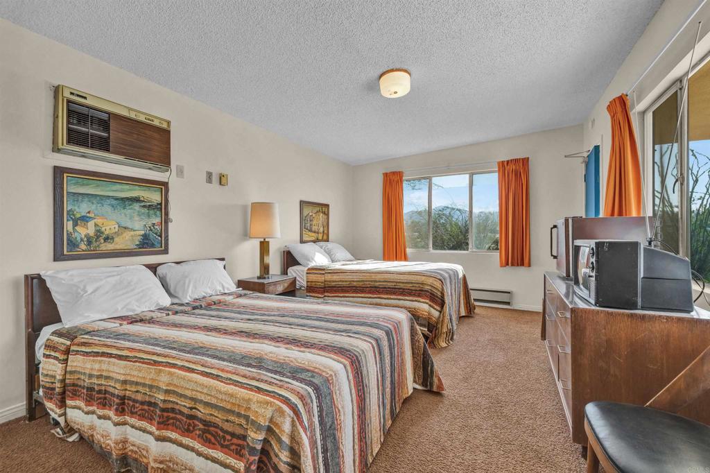 4235 Fletcher Road Borrego Springs, CA 92004 - Photo 18 of 31 a bedroom with a balcony a bed and a couch