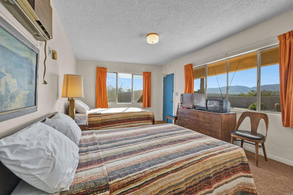 4235 Fletcher Road Borrego Springs, CA 92004 - Photo 19 of 31 a bedroom with a bed and a large window with outer view