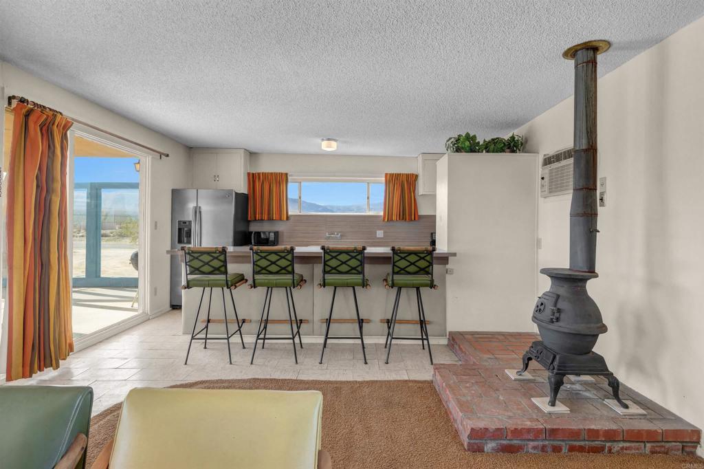 4235 Fletcher Road Borrego Springs, CA 92004 - Photo 7 of 31 a living room with furniture appliances and a large window