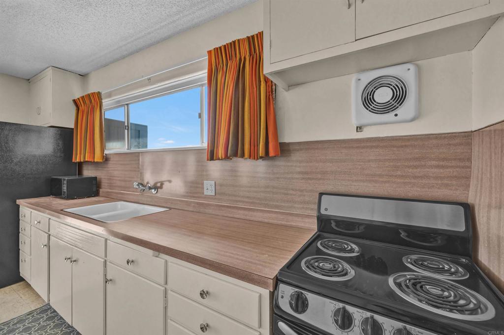 4235 Fletcher Road Borrego Springs, CA 92004 - Photo 10 of 31 a kitchen with a stove and a microwave