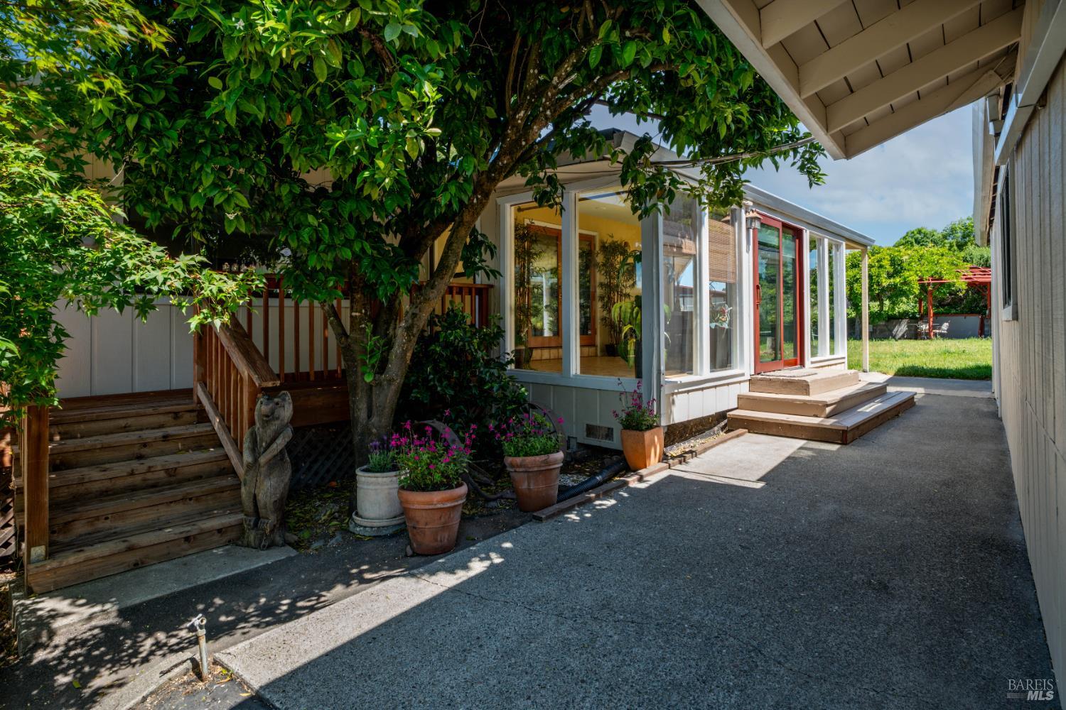 4901 Eastside Calpella Road Ukiah, CA 95482 - Photo 22 of 35 a view of a patio with a table and chairs under an umbrella with a small yard