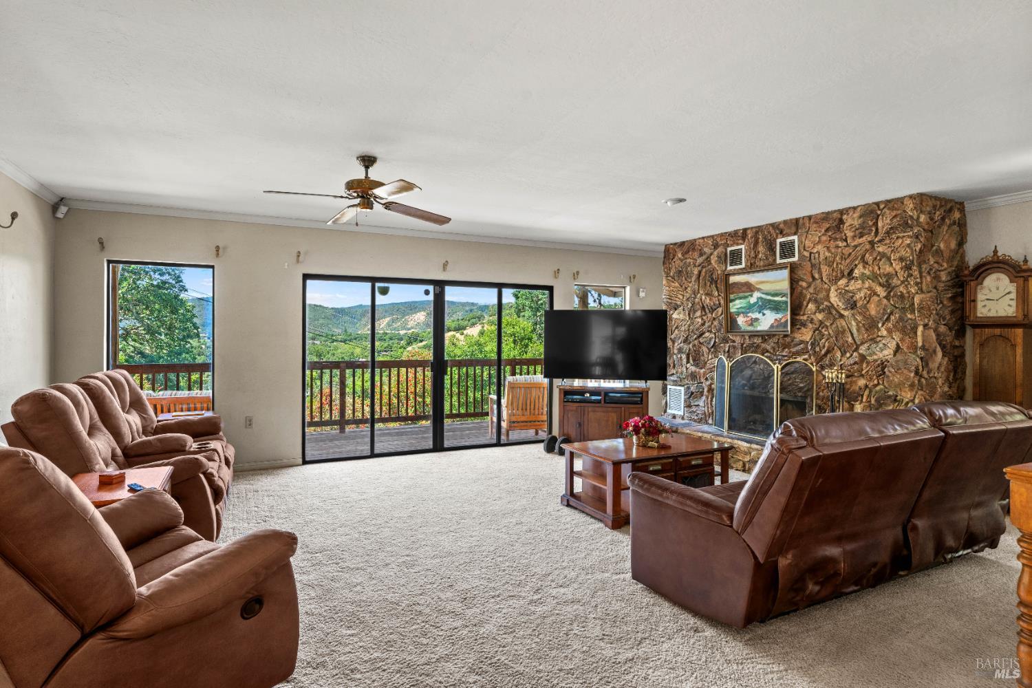 4901 Eastside Calpella Road Ukiah, CA 95482 - Photo 4 of 35 a living room with furniture a flat screen tv and a floor to ceiling window