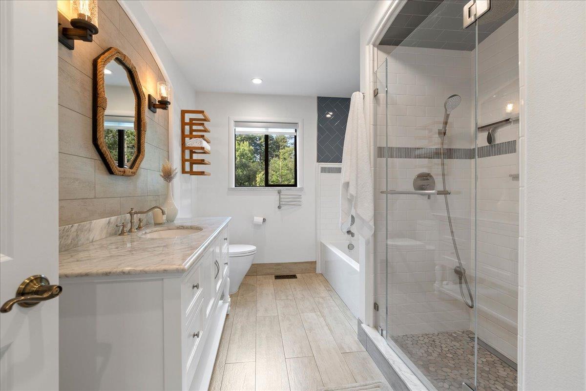 23435 Summit Road Los Gatos, CA 95033 - Photo 33 of 86 a bathroom with a granite countertop sink mirror vanity and toilet