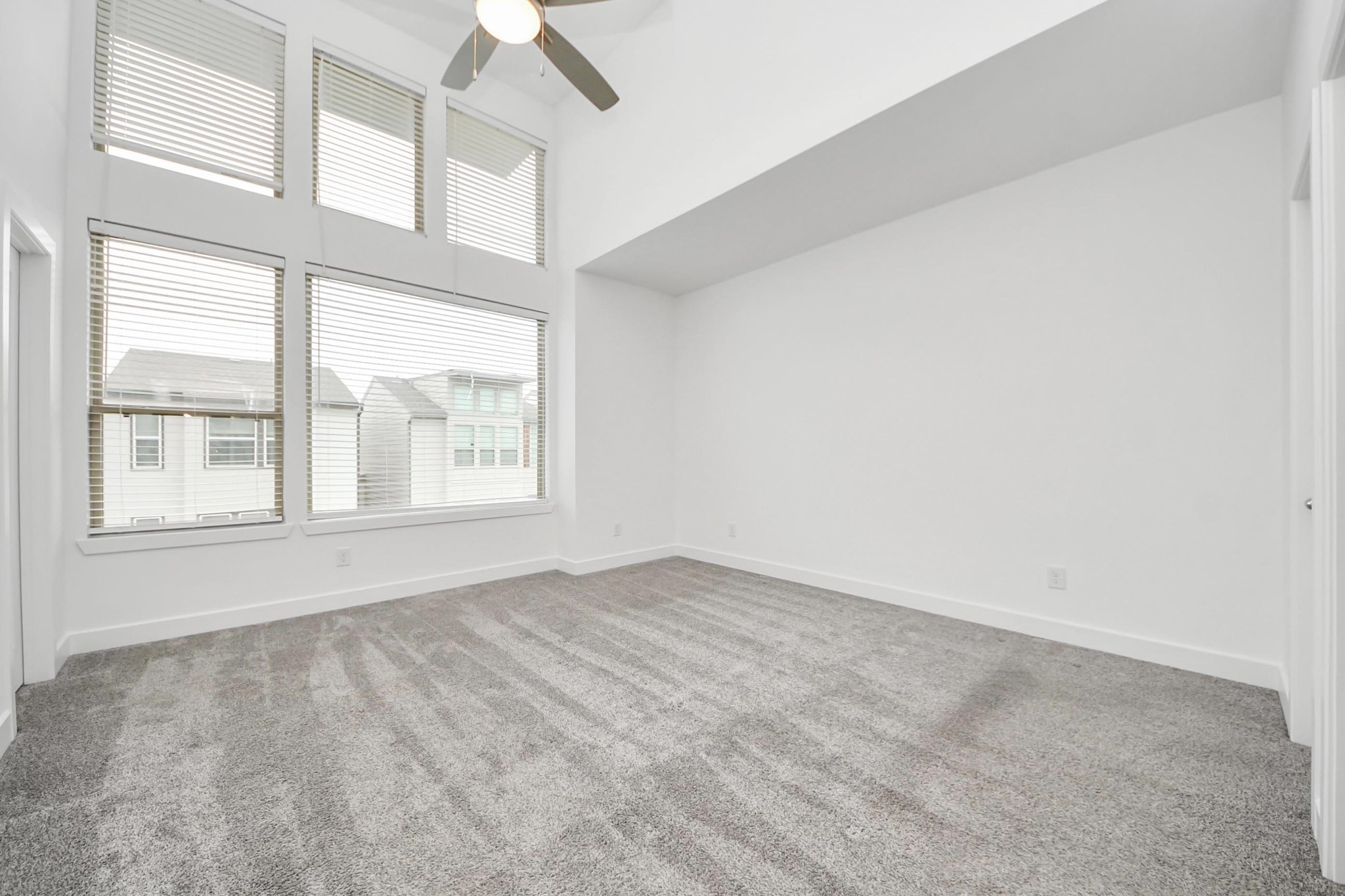 18527 Centro Row Conroe, TX 77385 - Photo 27 of 44 an empty room with a windows and chandelier fan