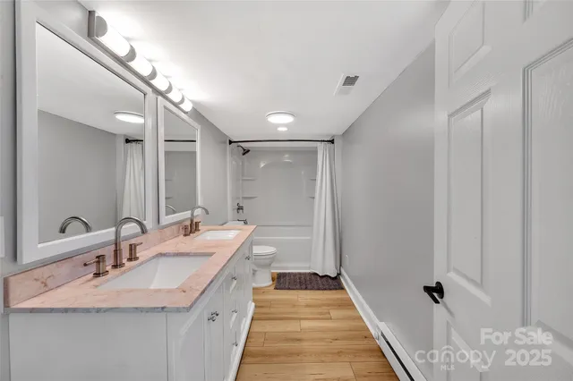 a bathroom with a double vanity sink and a mirror