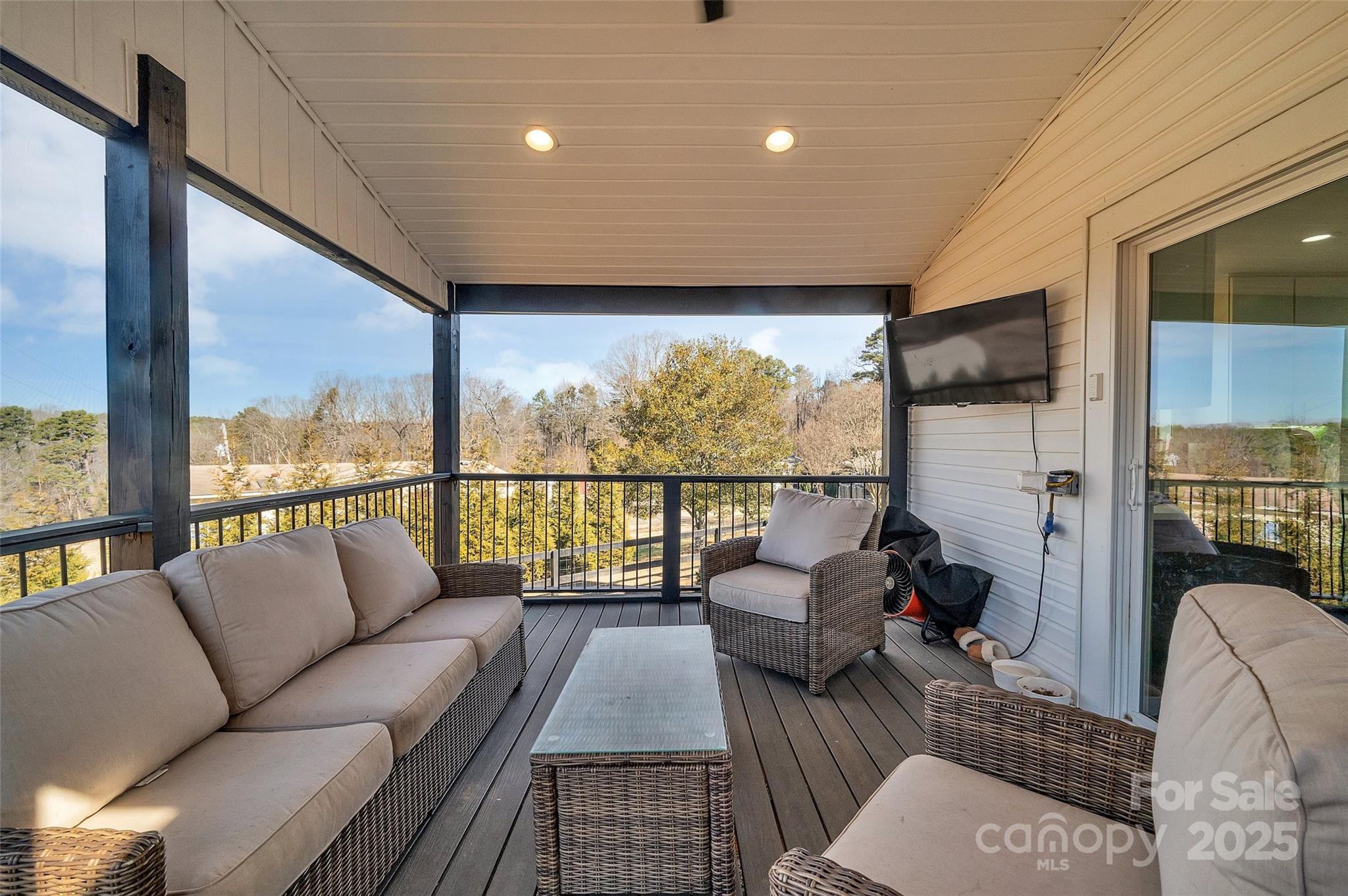3433 Grey Road Davidson, NC 28036 - Photo 20 of 25 a living room with furniture floor to ceiling window and a flat screen tv