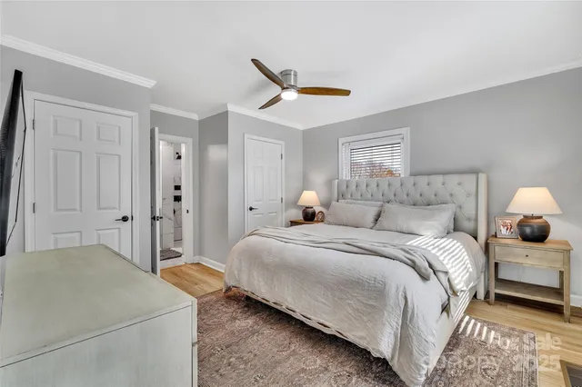 a bedroom with a bed and a ceiling fan