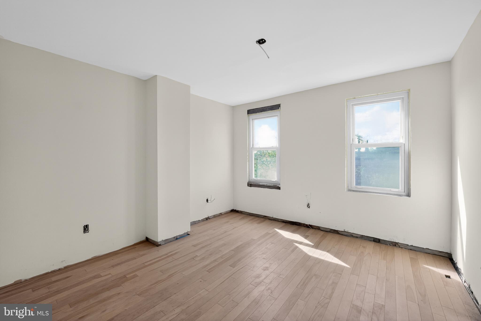714 Portland Street Baltimore, MD 21230 - Photo 4 of 18 an empty room with wooden floor and windows