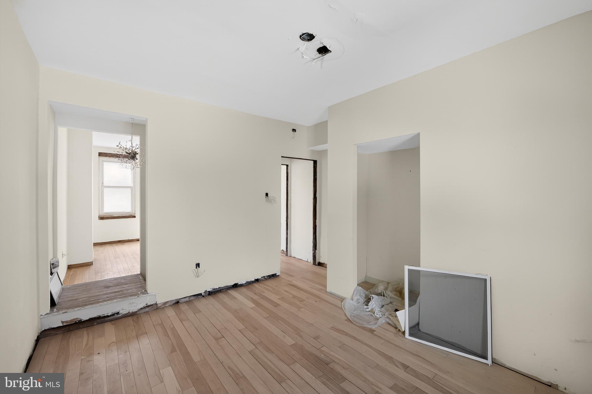 714 Portland Street Baltimore, MD 21230 - Photo 5 of 18 an empty room with wooden floor and windows