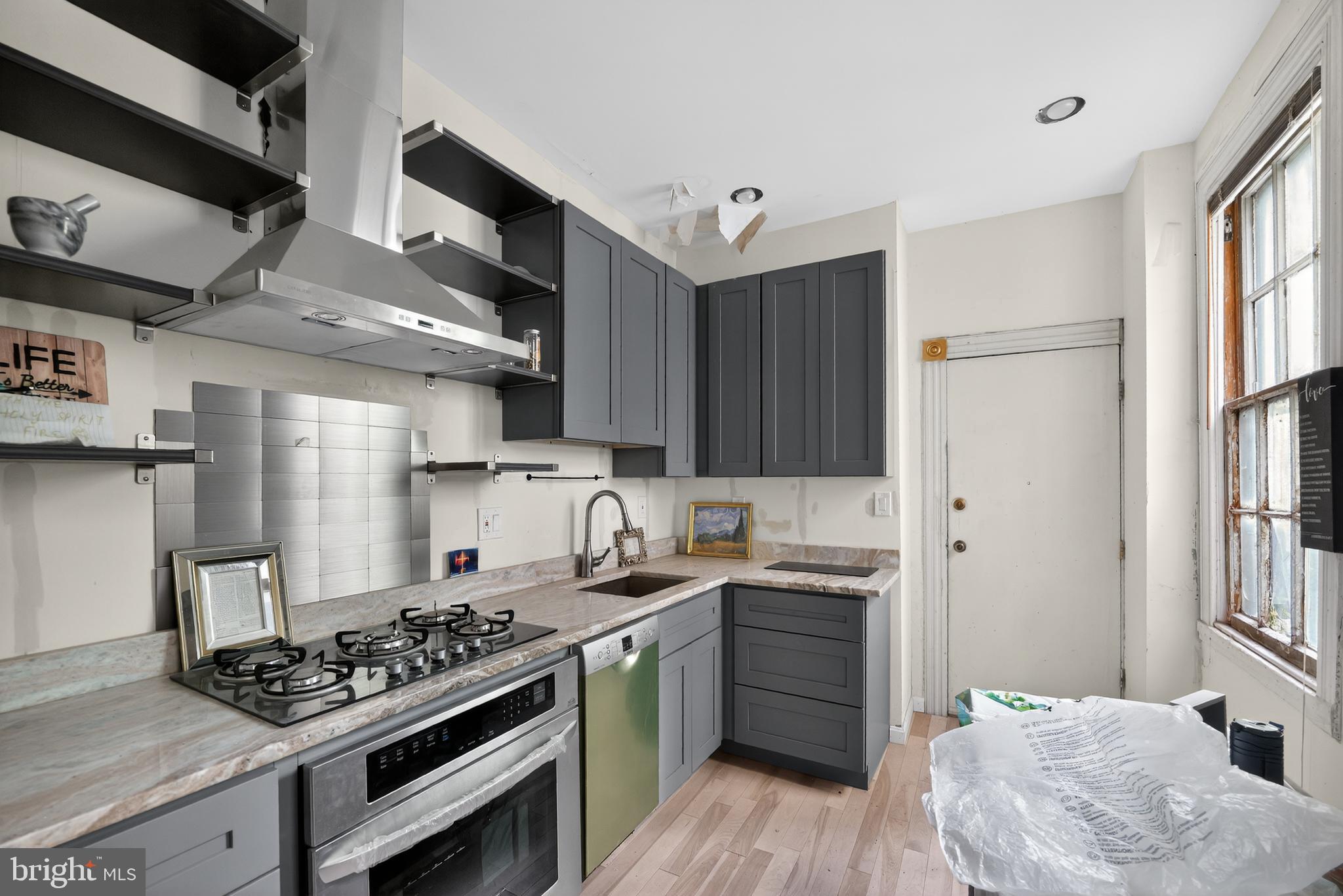 714 Portland Street Baltimore, MD 21230 - Photo 8 of 18 a kitchen with stainless steel appliances a sink stove and cabinets