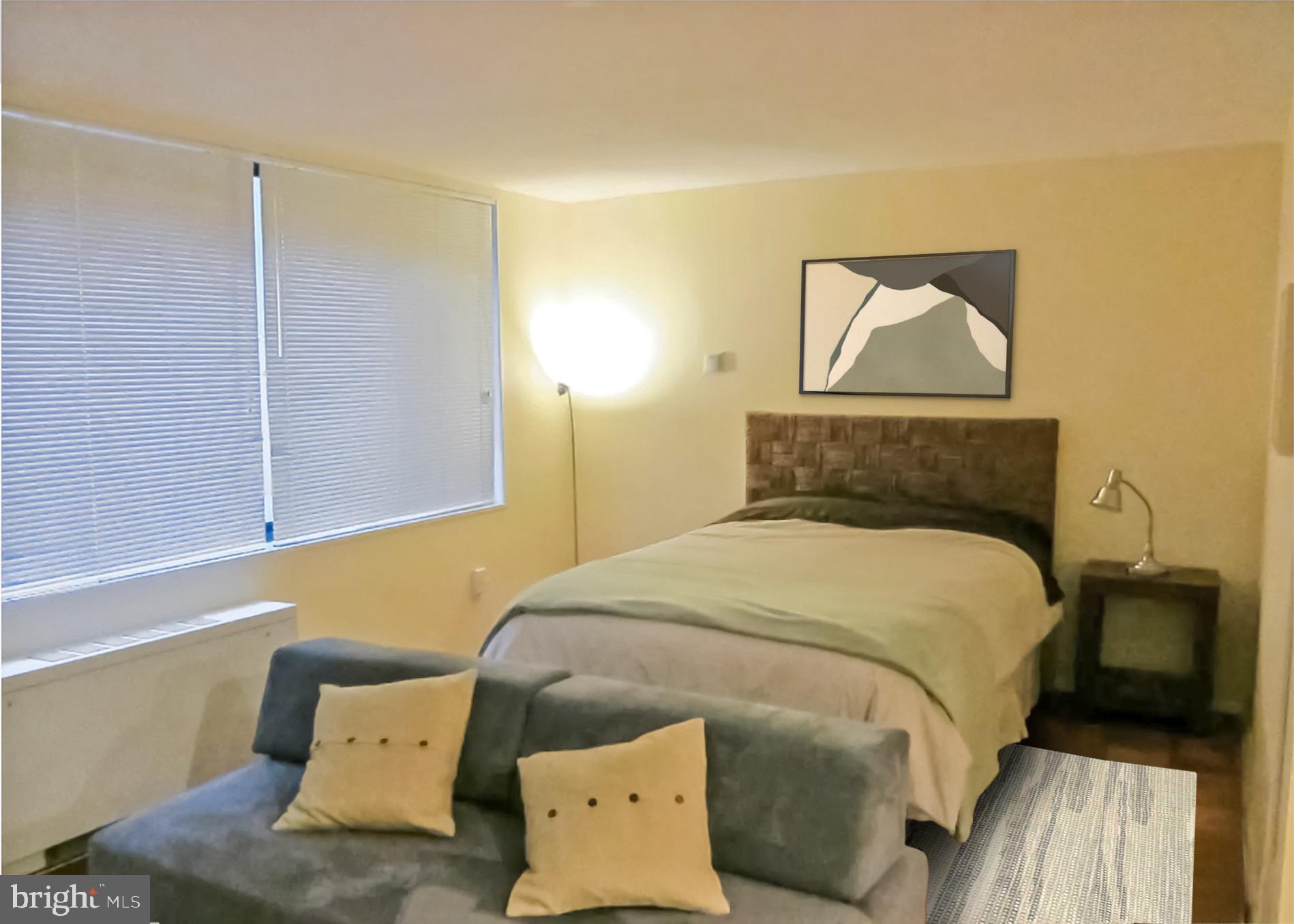 2030 F Street Northwest, Unit 211 Washington, DC 20006 - Photo 8 of 10 a bedroom with a bed and wooden floor