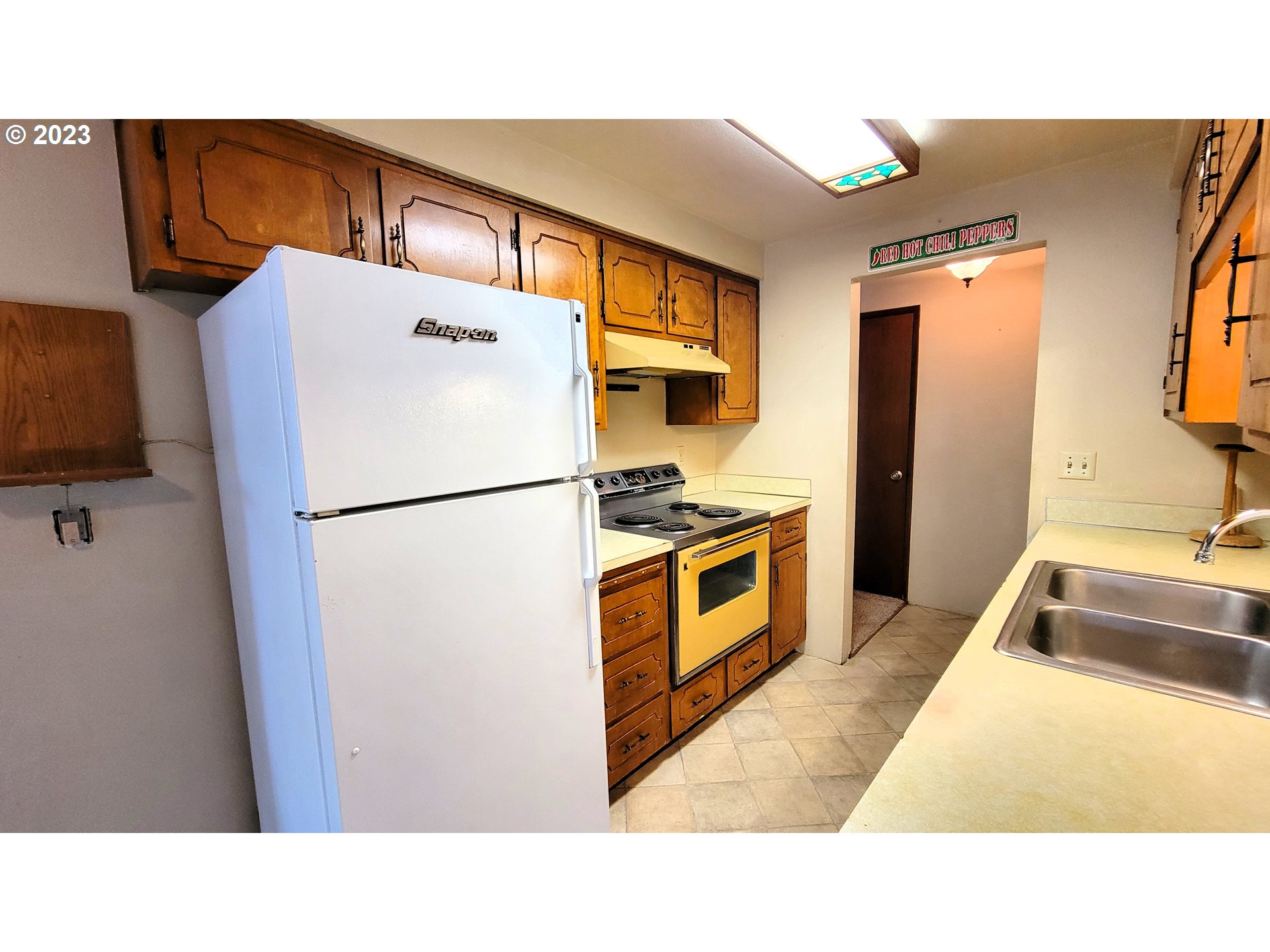 2055 Praslin Street Eugene, OR 97402 - Photo 4 of 14 a kitchen with stainless steel appliances kitchen island granite countertop a refrigerator and a sink