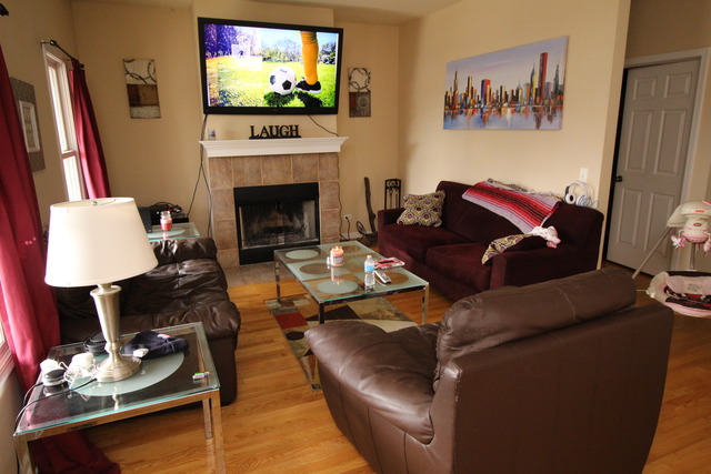 184 South Channing Street Elgin, IL 60120 - Photo 3 of 9 a living room with furniture a flat screen tv and a fireplace