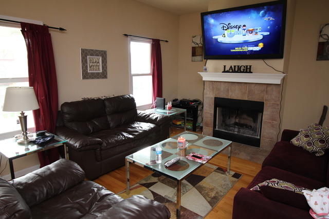 184 South Channing Street Elgin, IL 60120 - Photo 4 of 9 a living room with furniture a fireplace and a flat screen tv