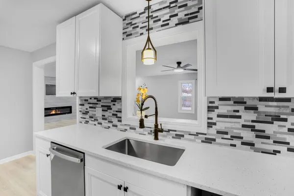 a kitchen with kitchen island a sink appliances and cabinets