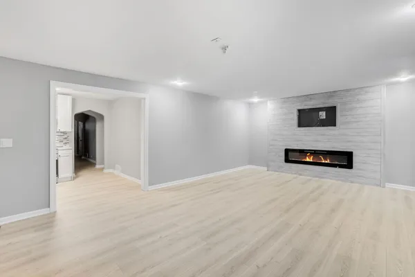 a view of empty room with a fireplace