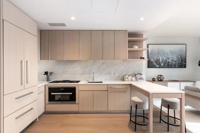 a kitchen with a table chairs stove and cabinets
