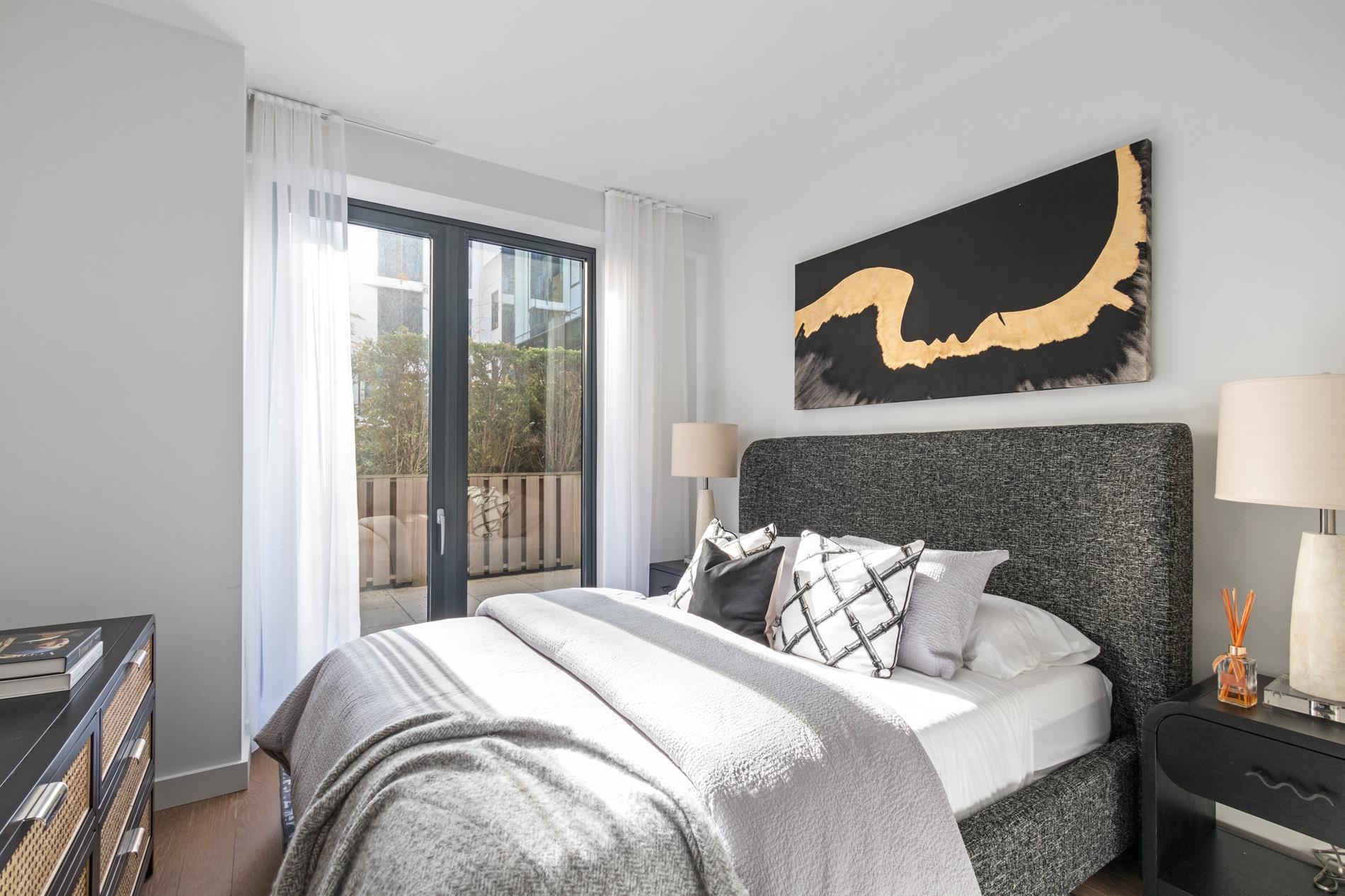 500 West 45th Street, Unit 230 Manhattan, NY 10026 - Photo 4 of 16 a bedroom with a bed and painting on the wall