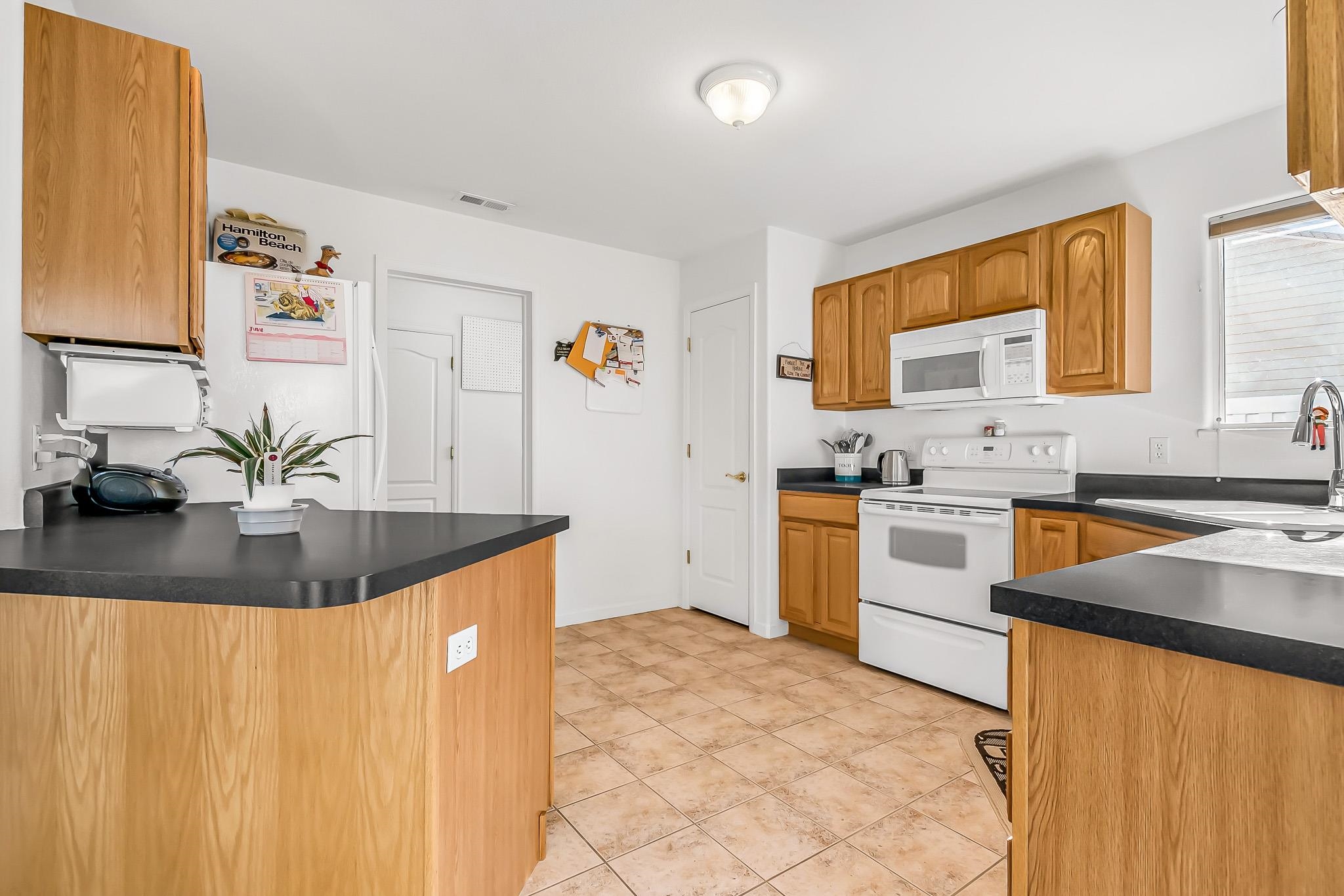 2833 B B 3/10 Road Grand Junction, CO 81503 - Photo 13 of 35 a kitchen with stainless steel appliances granite countertop a sink stove and refrigerator