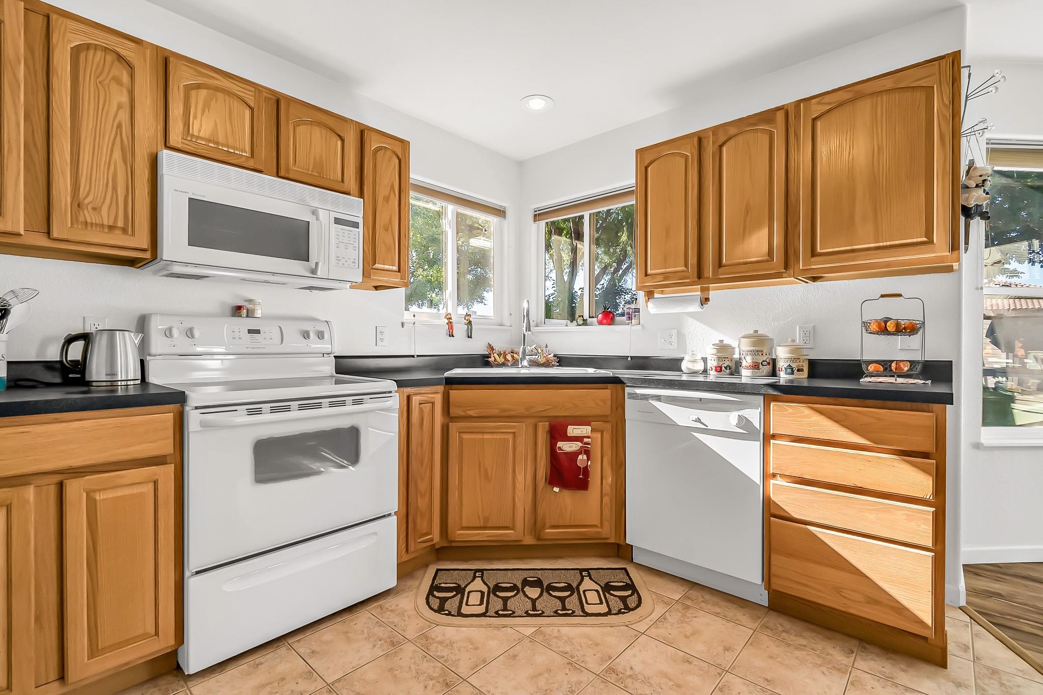 2833 B B 3/10 Road Grand Junction, CO 81503 - Photo 14 of 35 a kitchen with stainless steel appliances granite countertop a stove a sink and a refrigerator