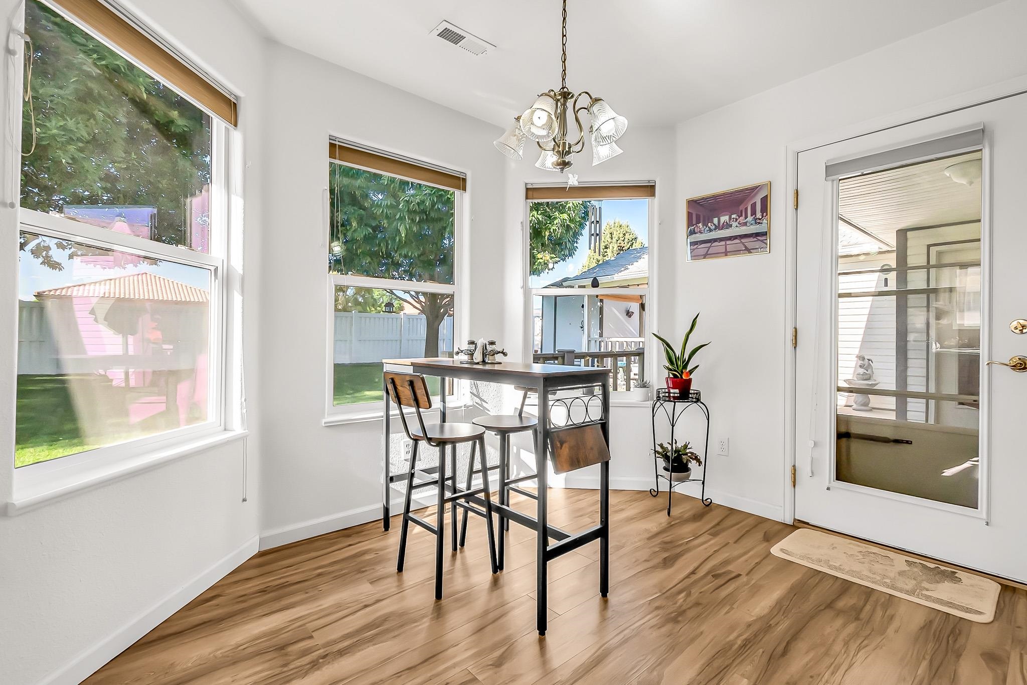 2833 B B 3/10 Road Grand Junction, CO 81503 - Photo 18 of 35 a view of a dining room with furniture window and wooden floor