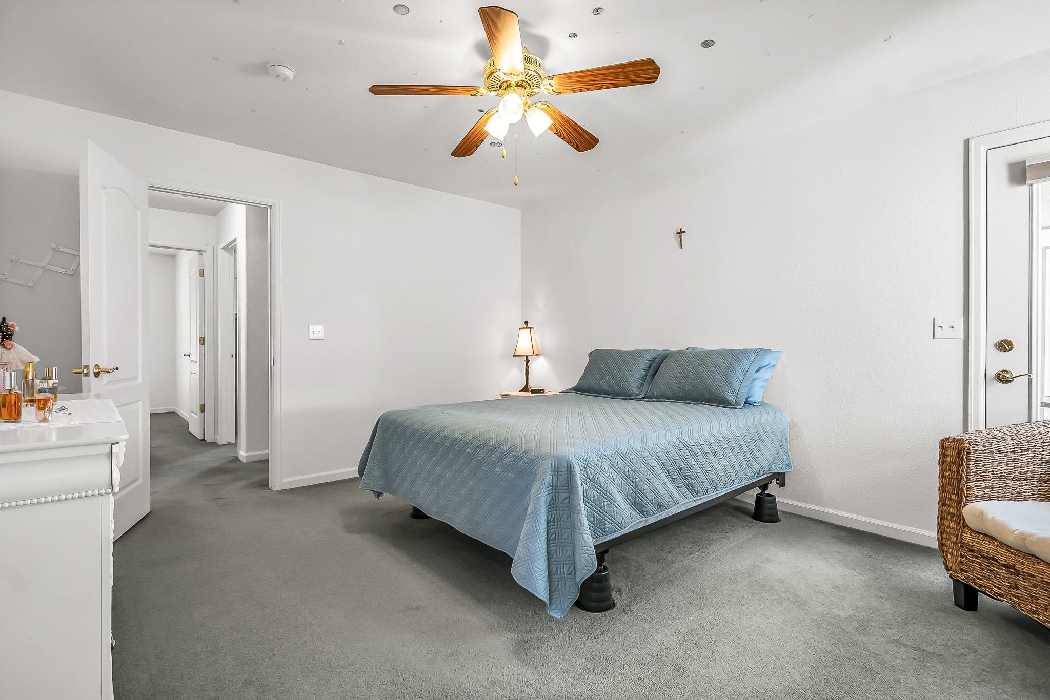 2833 B B 3/10 Road Grand Junction, CO 81503 - Photo 20 of 35 a bedroom with a bed and a chandelier