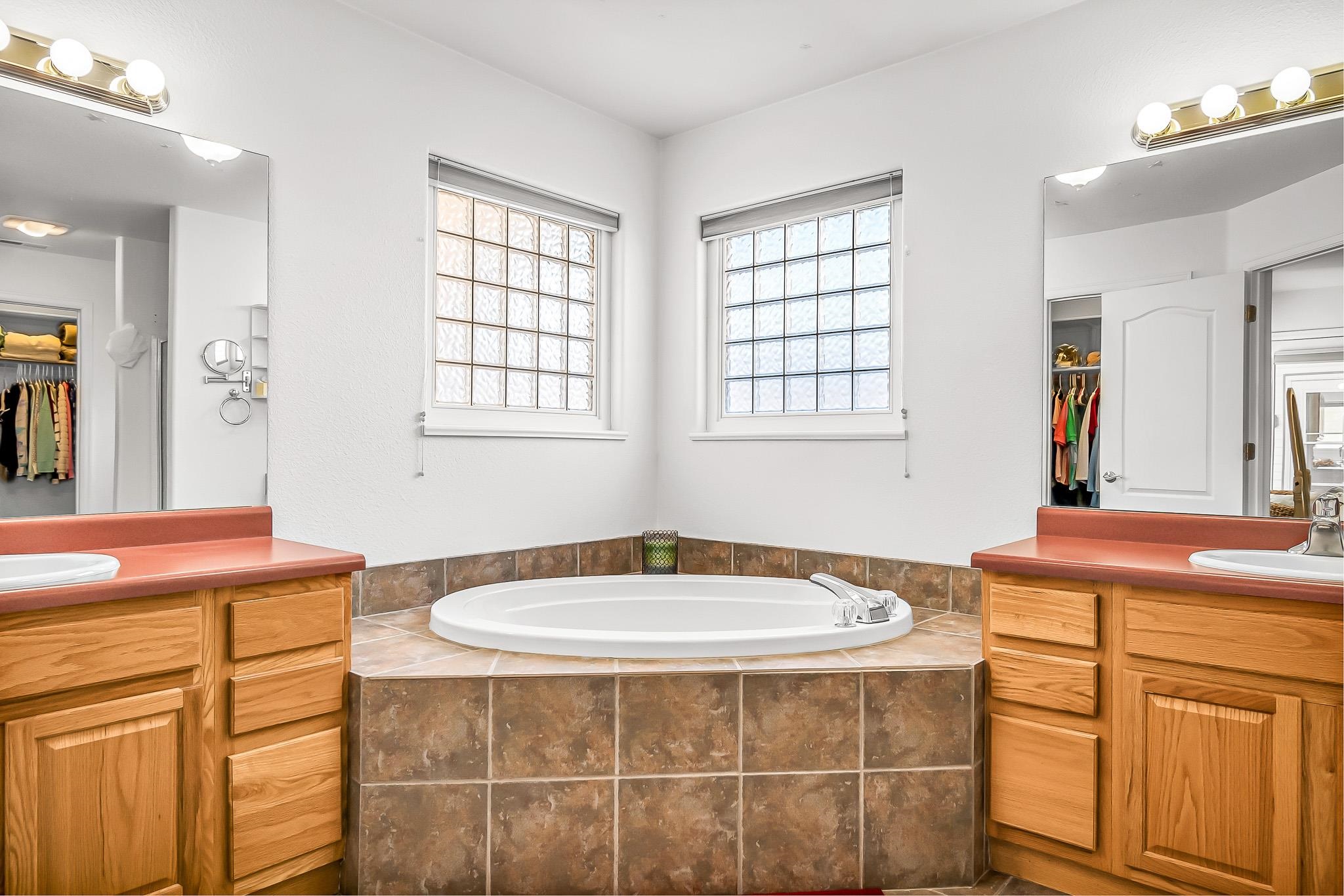2833 B B 3/10 Road Grand Junction, CO 81503 - Photo 21 of 35 a bathroom with a tub sink and mirror